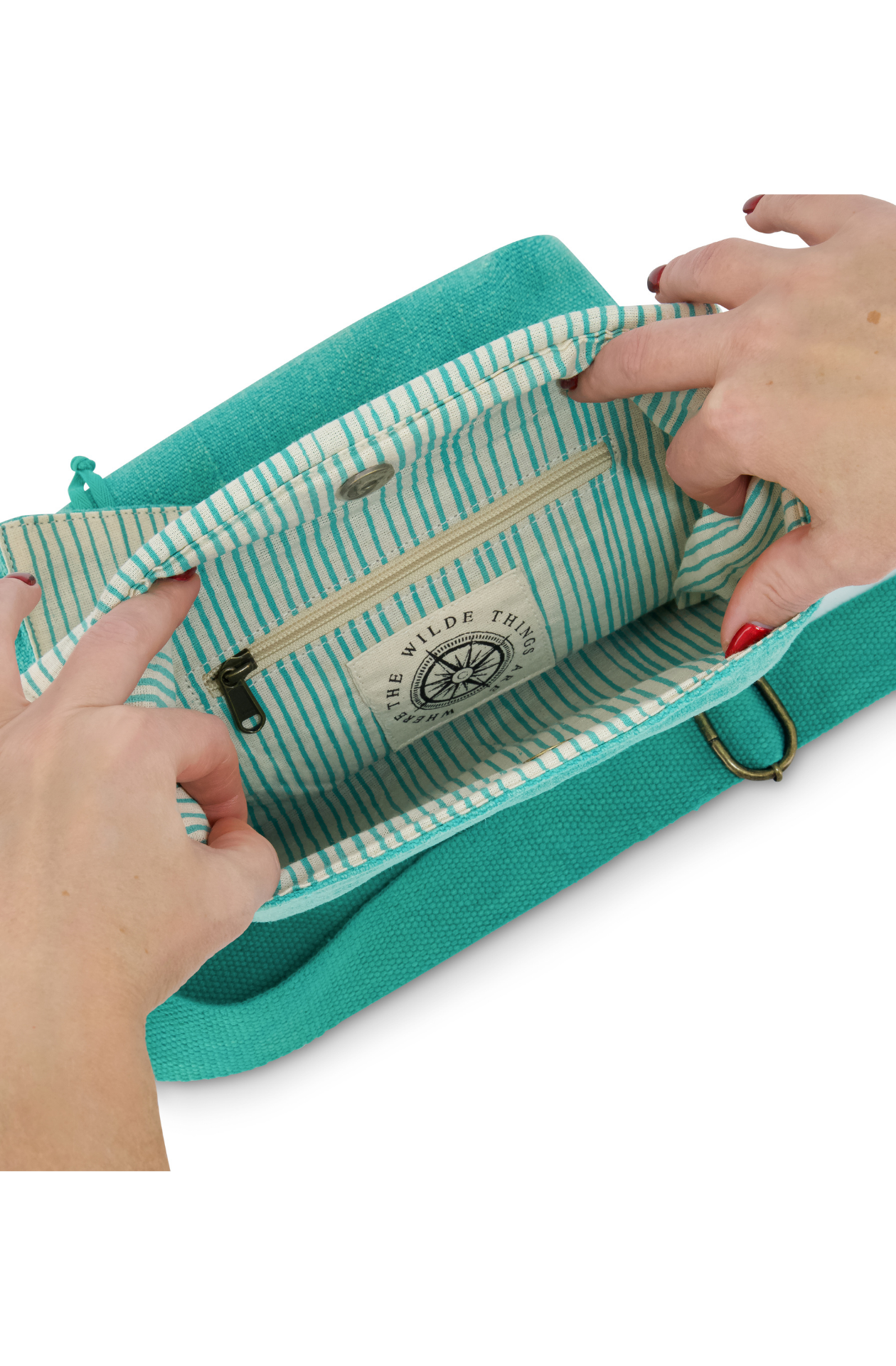 Eco-friendly jute soft sided cross body or shoulder bag, vegan friendy showing detail of striped cotton lining, compass logo and interior zipped pocket