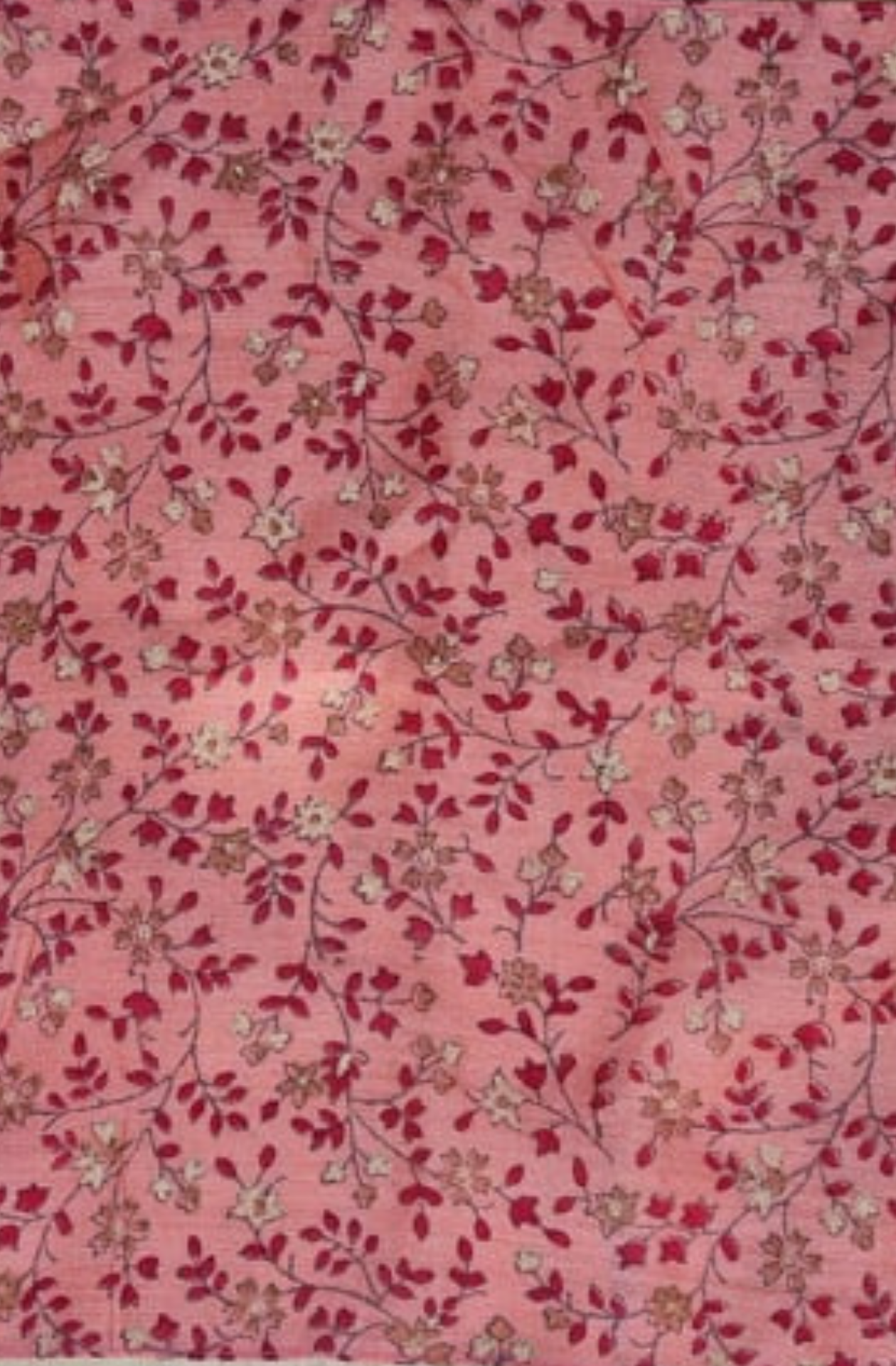 a close up of a pink, red and white floral patterned silk pocket square