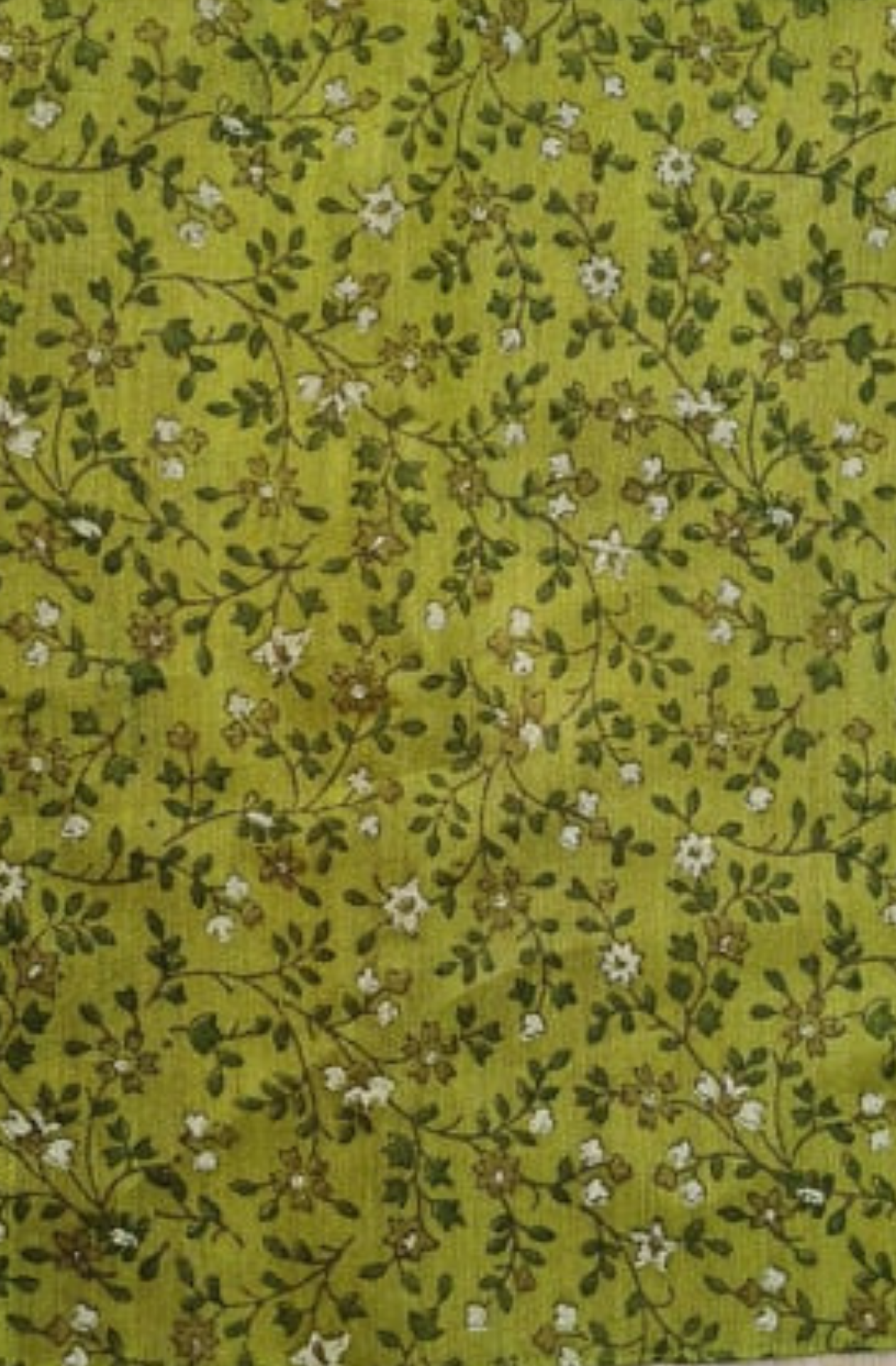 An olive green silk pocket square with a complimentary white and deeper green floral pattern