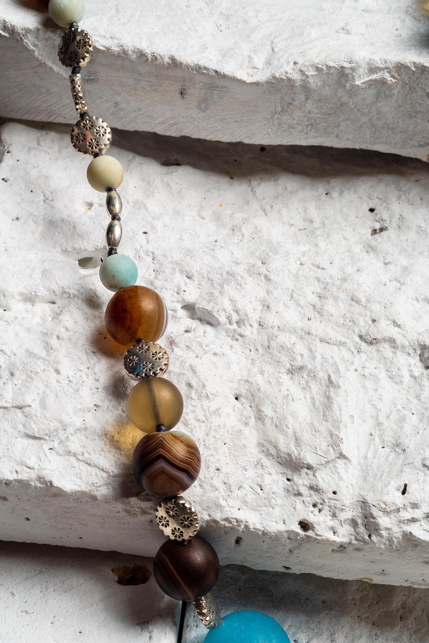 A close up of the variety of brown beads, some striped and some frosted glass