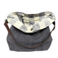 Charcoal grey sustainable jute shoukder bag folded open so the striped lining is showing