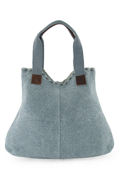 Chambray coloured ethically sourced jute tote bag, with soft woven cotton shoulder straps, reinforced with leather hand grips and soft leather trim where straps are joined to the tote.