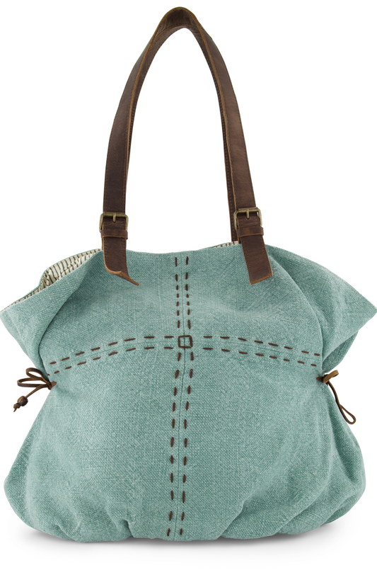 With a large carrying capacity and decorative hand stitching, the shoulder bag has leather side ties to give it an appealing shape and two leather shoukder straps with decorative brass buckles. Its colour is a French Blue, made from ethically sourced jute