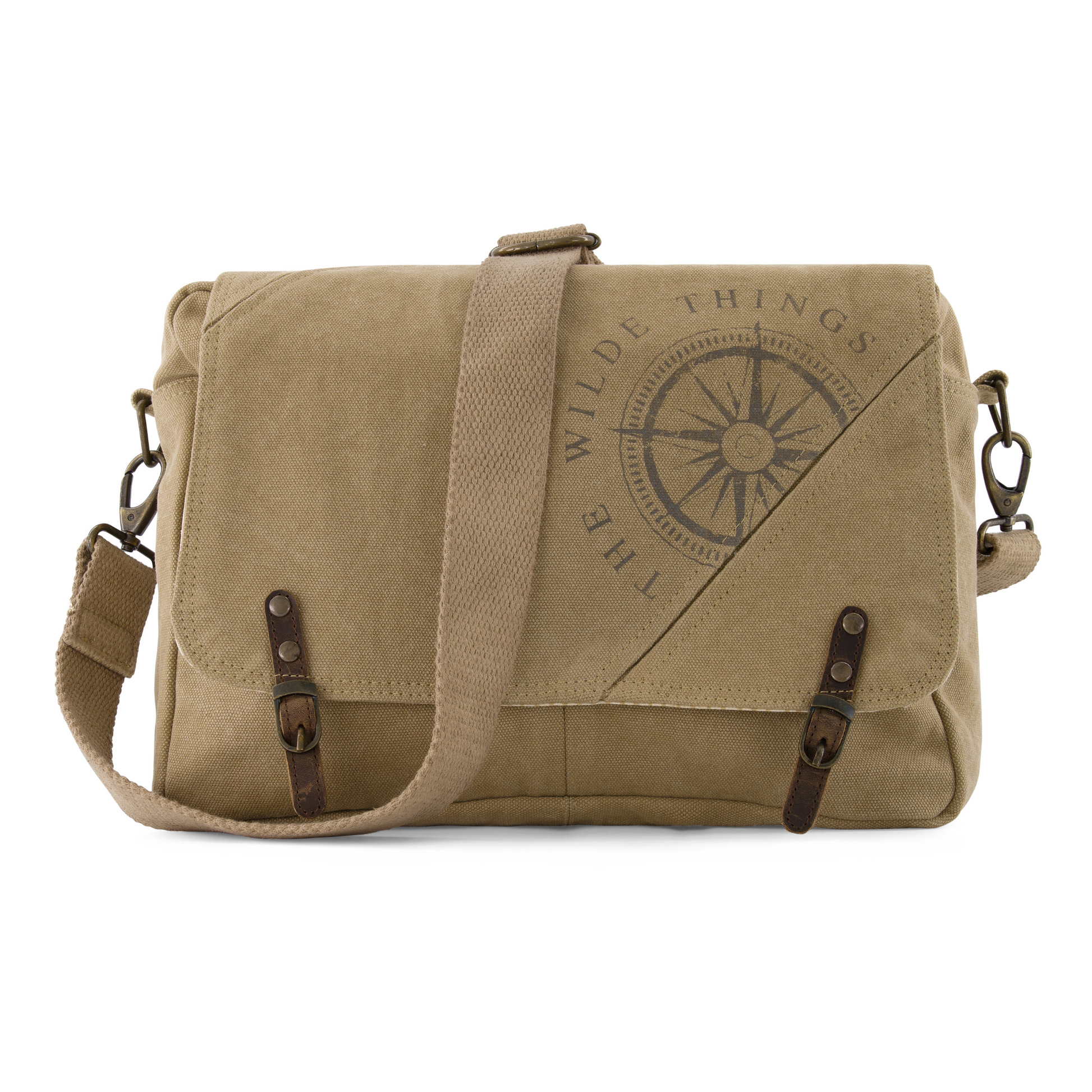 a canvas crossbody satchel with strap drapped over the front, showing compass logo screen printed on the front, leather tabs, and brass hardware attaching the adjustable strap to the sides of the satchel