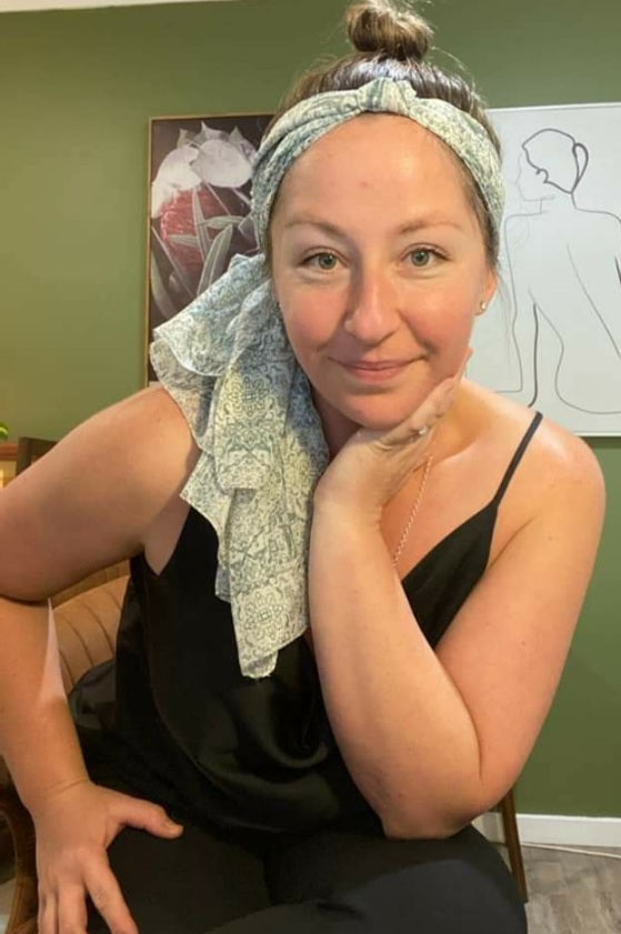 A woman wears the blue mist scarf as a headband.