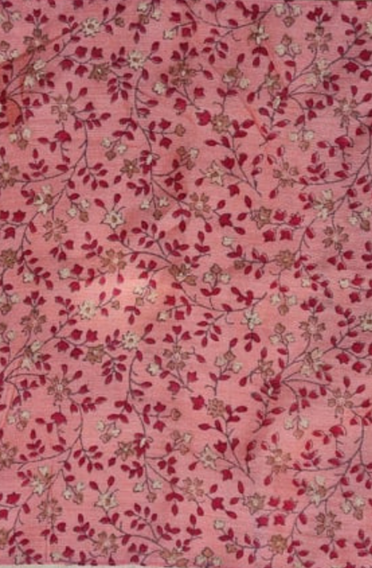 a close up of a pink, red and white floral patterned silk pocket square